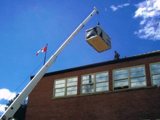 All Purpose Roofing Commercial crane bringing in roofing supplies